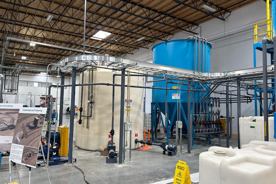 Water-treatment and filtration equipment at a demonstration facility: a storage tank, stainless processing vessels and pipe skids